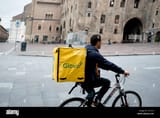 bologna-italy-13-april-2019-young-immigran-glovo-rider-making-delivery-on-his-bike-working-in-the-so-called-gig-economy-in-an-italian-town-T51K1A