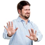 irritated-man-with-hands-out-in-stop-gesture
