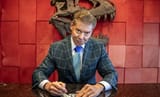 01-vince-mcmahon-signs-contract-new-company-paper-document-desk-office-backstage-2025