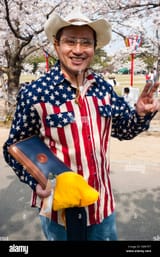 smiling-japanese-man-posing-under-cherry-blossoms-in-japan-wears-stars-EWKTF7