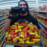 Seth Rollins in a store with 100 candy bars, security camera style