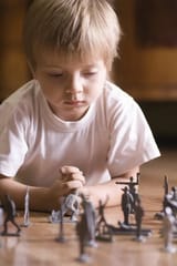 boy-playing-toy-soldiers-floor-closeup-young-33899947