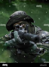 special-operations-forces-soldier-transits-the-water-armed-with-an-C7WMPM
