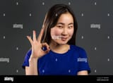 young-asian-woman-making-ok-sign-over-grey-background-winner-success-positive-korean-girl-smiles-to-camera-body-language-2BBPDA8
