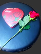 single rose and a box of chocolates