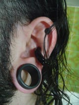 1200px-Back_on_the_earlobe_stretching_(1428332499)