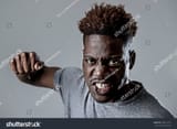 stock-photo-young-attractive-african-american-black-man-in-rage-threaten-punching-with-fist-in-angry-upset-and-598719917