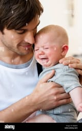 father-holding-crying-baby-BMJK09