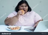 stock-photo-fat-woman-eats-a-hamburger-and-plays-computer-792403528