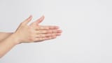 male-model-is-rubbing-hand-plams-together-on-white-background-photo