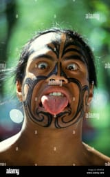 young-man-making-traditional-maori-face-haka-war-greeting-rotorua-A9WR3K