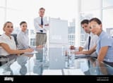 serious-business-people-looking-at-camera-during-a-meeting-in-the-meeting-room-WXM1ND