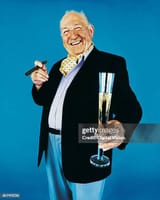 portrait-of-a-wealthy-man-holding-a-tall-glass-of-champagne-3872623809