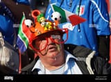 a-spectator-wears-a-lekarapa-colorfully-decorated-with-flags-and-figures-D20BHP