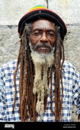 portrait-of-a-middle-aged-older-jamaican-rastafarian-man-wearing-a-AX2NBH
