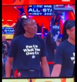 player-wearing-pay-us-what-you-owe-us-t-shirts-v0-whtuelnccxdf1