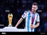 lusail-qatar-18th-dec-2022-soccer-world-cup-argentina-france-final-round-final-lusail-stadium-argentinas-nicols-tagliafico-looks-at-the-world-cup-trophy-during-the-award-ceremony-credit-tom-wellerdpaalamy-live-news-