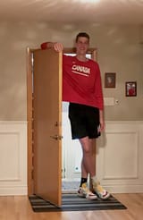 tallest-teenager-living-male-standing-in-doorway-to-home-small