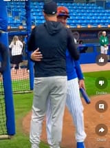 CARLOS MENDOZA AND AARON BOONE HUG