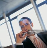 portrait-of-a-young-ceo-smoking-a-cigar-3034422578
