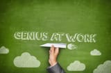 genius-work-concept-green-blackboard-businessman-hand-holding-paper-plane-56220232