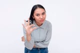 a-frustrated-young-asian-woman-bending-down-and-asking-for-a-little-more-effort-gesturing