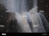 close-up-of-violently-foaming-water-plunging-off-the-edge-of-a-dramatic-waterfall-the-top-half-of-which-is-in-the-background-R8DJMW-3710915211