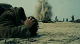 dunkirk guy casually standing around as a bomb goes off