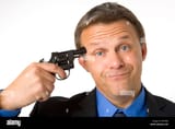 businessman-holding-gun-to-head-B4YW9J