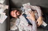 top-view-man-enjoying-his-money-handsome-happy-man-financial-freedom-enjoying-feeling-rich-bathing-money-246208912