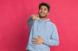 happy-indian-young-man-laughing-out-loud-hearing-ridiculous-anecdote-reaction-funny-joke-feeling-carefree-amused-positive-375403910