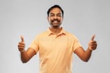 portrait-happy-indian-man-showing-thumbs-up-people-furniture-concept-smiling-young-over-grey-background-191878081