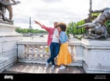 black-cheerful-happy-couple-in-love-visiting-paris-city-centre-and-eiffel-tower-african-american-tourists-travelling-in-europe-and-dating-outdoors-2JFC68H