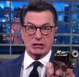 Stephen Colbert pointing gun