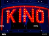 illuminated-kino-cinema-sign-lit-lighted-up-behind-a-curved-window-MB54BD