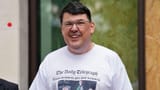 Graham Linehan outside court in a T-shirt showing a headline reading Trans women are not women