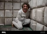 mad-crazy-man-patient-wearing-straitjacket-laughing-terrifying-2TBNFEJ