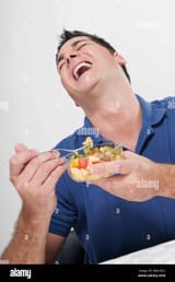 man-laughing-while-eating-fruit-salad-BM1WC2