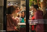 young-friends-with-drinks-having-fun-at-restaurant
