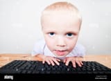 cute-child-looking-at-a-computer-screen-E1G5HX