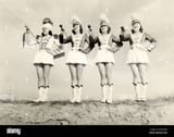 four-marching-band-majorettes-at-edge-of-cliff-BH2EDW