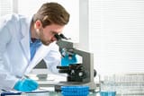 scientist-looking-through-a-microscope