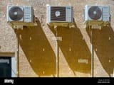 3-air-conditioning-units-on-a-french-house-wall-W2TYGD