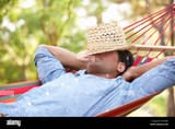man-relaxing-in-hammock-D470GK-1225033104