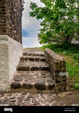 stone-stairs-with-a-small-stone-wall-at-the-side-of-the-building-2F1MFE0
