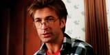 alec-baldwin-as-adam-maitland-looking-at-something-in-his-house-in-beetlejuice