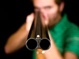 man-pointing-a-shotgun-at-the-target-and-ready-to-shoot-picture-id140260345-159098577-1