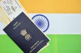 blue-indian-passport-with-airline-tickets-flag-background-close-up_76080-79661