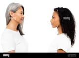 side-view-of-happy-african-american-and-asian-women-looking-at-each-other-isolated-on-white-2AYRB0F