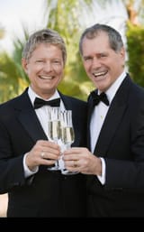 newlywed-gay-couple-toasting-each-other-with-champagne-AHEMWN